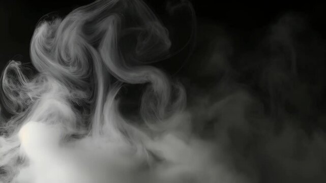 thick gray fog softly swirling against a backdrop of darkness. This atmospheric image of mist captures the ethereal beauty of nature's veiled mystery