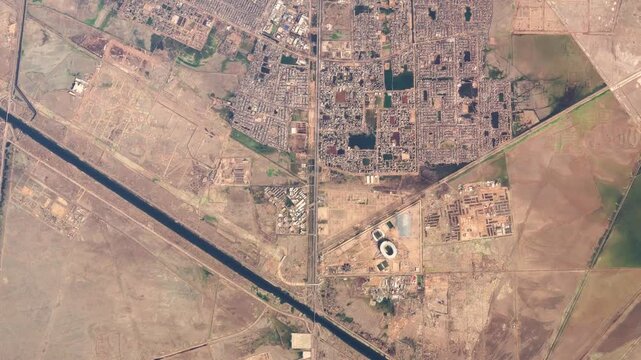 Aerial high altitude airplane top down view of downtown Basra also known as Venice of the East It is the capital of the eponymous Governorate as well as the third largest city in Iraq 4k animation