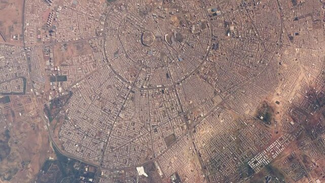Aerial high altitude airplane top down view of Erbil Iraq also called Hawler is the capital and most populated city in the Kurdistan Region of Iraq also showing the ancient citadel 4k animation