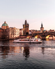 Obraz premium Sunset colors in Prague Historical Gothic Medieval castle, St. Vitus Cathedral, Charles Bridge and river Vltava boat cruise, astronomical clock, Unesco city tourism, golden hour and water reflection