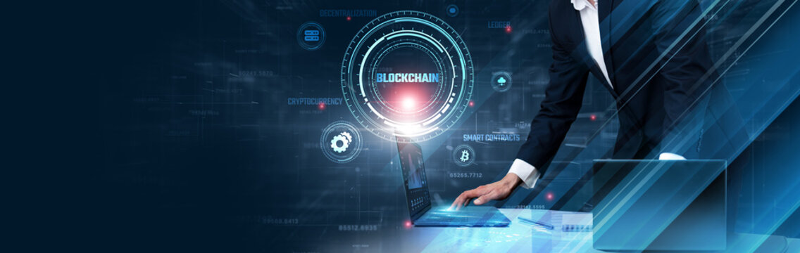 Blockchain Technology: Businessman uses laptop and synchronize data of transactions on computer device with global network, decentralized ledger, cryptography, smart contracts, security, transparency.
