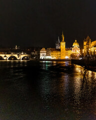 Obraz premium Sunset colors in Prague Historical Gothic Medieval castle, St. Vitus Cathedral, Charles Bridge and river Vltava boat cruise, astronomical clock, Unesco city tourism, night view and water reflection