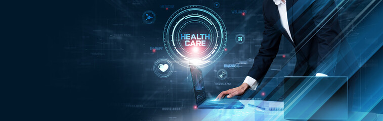 Fototapeta premium Medical Health Care: Businessman uses laptop and synchronizes data of patient records on a computer device with a global network, telemedicine, diagnostics, electronic health records, AI in healthcare