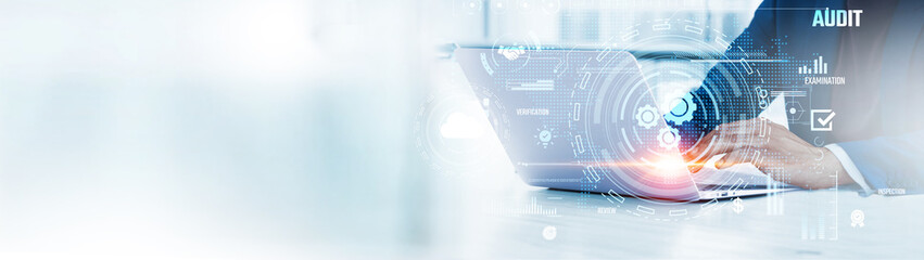 Audit: Businessman uses laptop to analyze and develop various information about financial records...