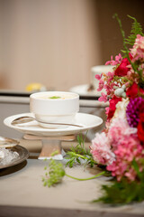 clam chowder and spoon on plate with flowers