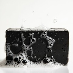 Lathered Charcoal Bar: Soap bubbles cling to a dark, cleansing charcoal bar.