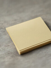Fototapeta premium Stack of yellow sticky notes on a textured gray surface.