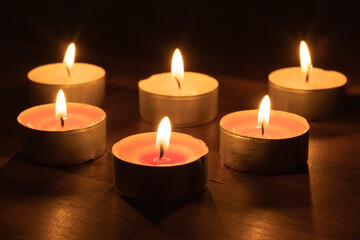 Serene Glow of Six Lit Tea Light Candles Tonight