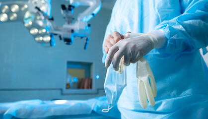 Surgeon Preparing for Operation in Modern Operating Room with Surgical Equipment