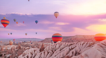 Aerial view amazing sunrise landscape in Cappadocia with colorful hot air balloon fly in sky over...