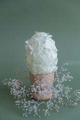 Creative Easter egg shape made of white lilac spring petals flowers. Responsible holidays decoration. Minimal holiday concept still life. Copy space greeting card postcard 