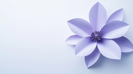 Fototapeta premium A soft lavender paper flower on a crisp white background, creating a minimalist design with open copy space