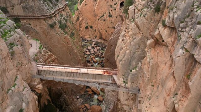 Garganta Gorge, del Chorro and Caminito del Rey, Spain. Aerial shot of a bridge in a narrow gorge, a river flows below. 