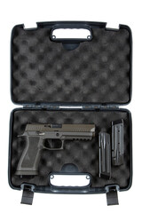 A handgun in a foam-lined carrying case with two magazines, showcasing its safety and protection features.