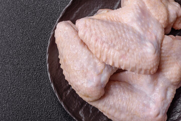 Raw chicken wings with salt, spices and herbs