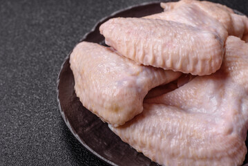 Raw chicken wings with salt, spices and herbs
