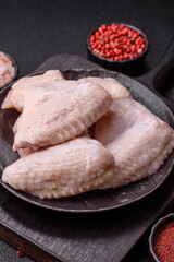 Raw chicken wings with salt, spices and herbs
