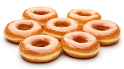 Freshly glazed donuts arranged in a circular pattern on a white background, perfect for desserts