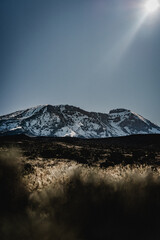 Mount Kilimanjaro surrounded by grassy plains an sun rays