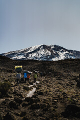 Porters carrying bags on the trail to Mount Kilimanjaro in Tanzania Africa