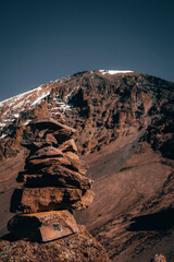 A stack of rocks in front of Mount Kilimanjaro in Tanzania Africa