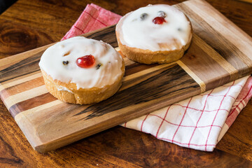 Iced Belgian Buns on wooden board