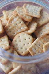 Savory crackers in a clear container for snacking or serving