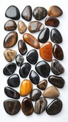 Colorful polished stones of various sizes are arranged in a neat pattern on a light surface