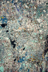 Detailed abstract texture of an aged and weathered surface featuring peeling paint in earthy and blue shades. Perfect for digital art, backgrounds, and creative design projects.