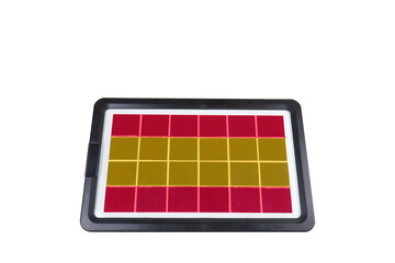 Portable solar panel in the form of the flag of Spain on a transparent background (close-up). Concept for the development of renewable green alternative energy in Spain