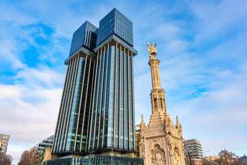 Glass and steel skyscrapers next to the statue of Columbus in the center of Madrid, Spain