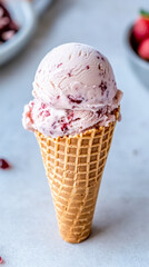 Close-up of classic waffle cone with scoop of strawberry ice cream. Concept of sweet desserts, delicious treats, summer indulgence, refreshing flavors. Vertical shot
