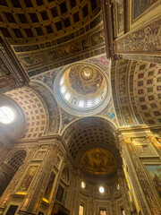 Church Sant'andrea, Mantua, Italy. An ornate church interior with a grand columns and detailed frescoes enhance the stunning architectural beauty of the building.