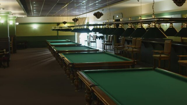 No people full shot of interior of empty modern public billiards club with row of baize tables