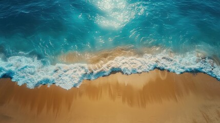 Drone shot of a beautiful tropical beach. The clear blue sea sparkles under the sun, waves gently rolling onto the sandy shore. A perfect scene