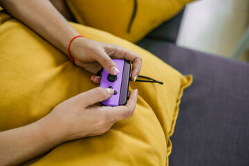 Hands using game controller. Playing video games