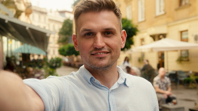 Mobile phone view camera selfie record video blog Caucasian man tourist guy male traveler businessman blogger vlogger influencer social media travel streaming hello talking outdoors city online call