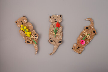 Otter-shaped cardboard crafts holding paper flowers. Mother Day. Recycling cardboard. Design for school project, sustainable decor, kids activity, creative handmade gift.