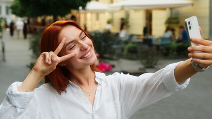 Happy smiling Caucasian woman girl tourist female student blogger vlogger influencer in city...