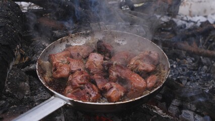 Enjoy the smoky aroma of sizzling meat cooking deliciously over an open flame in the great outdoors.