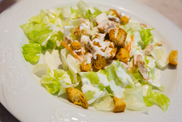 Caesar salad on plate at restaurant. High quality photo