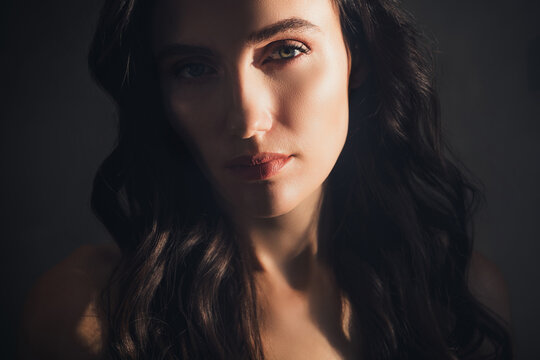 Phoo of pretty girl look in camera feeling tempting under sunlight over dark color background