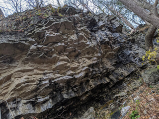 Rock strata overhang in the forest on the Bruce Trail. A part of the Niagara Escarpment in Ontario during the fall