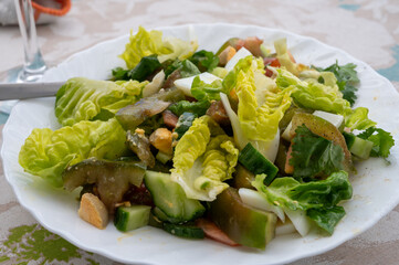 Green healthy salad with green romaine lettuce, kumato tomatoes, eggs and cucumbers