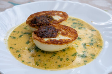 Les Oeufs Jeannette (Eggs Jeannette) with special filling and yellow sauce, vegetarian food