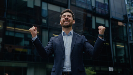 Excited businessman rich guy winner male entrepreneur happy business man investor celebrate success invest real estate triumph win amazing good news job offer hire celebration happiness city outdoors