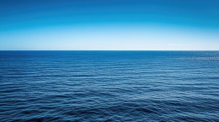 Obraz premium A bright blue sky meeting a clear horizon over a still ocean, endless open space.