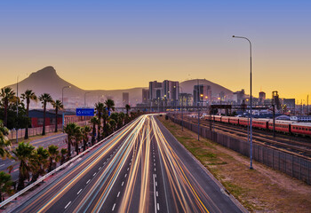 Obraz premium N1 Highway Light Trails Stretching from Cape Town City on a Hazy Day, South Africa