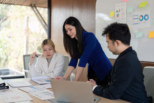 Business team collaborating on project analysis and data presentation during a meeting, focusing on insights and strategic planning.