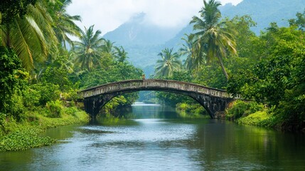 A humped-back bridge crossing a peaceful river surrounded by lush greenery